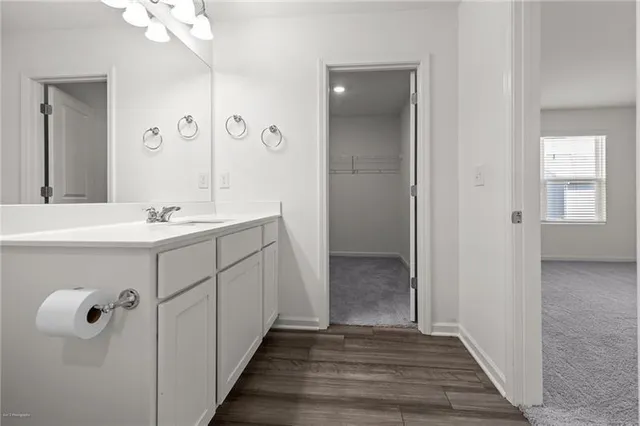a bathroom with a sink mirror and vanity