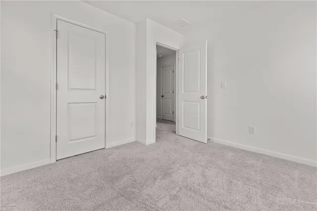 a view of an empty room and closet area