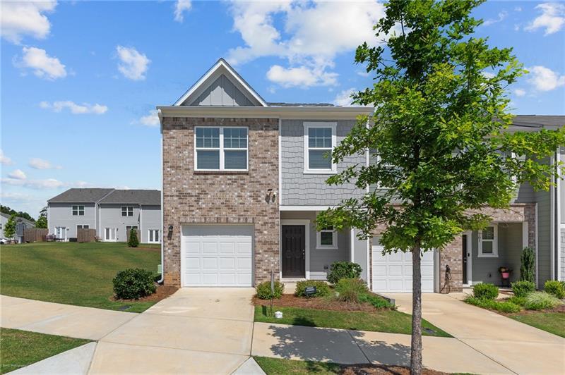 103 Rydal Way Winder, GA 30680 - Photo 25 of 31 a front view of a house with a garden and trees