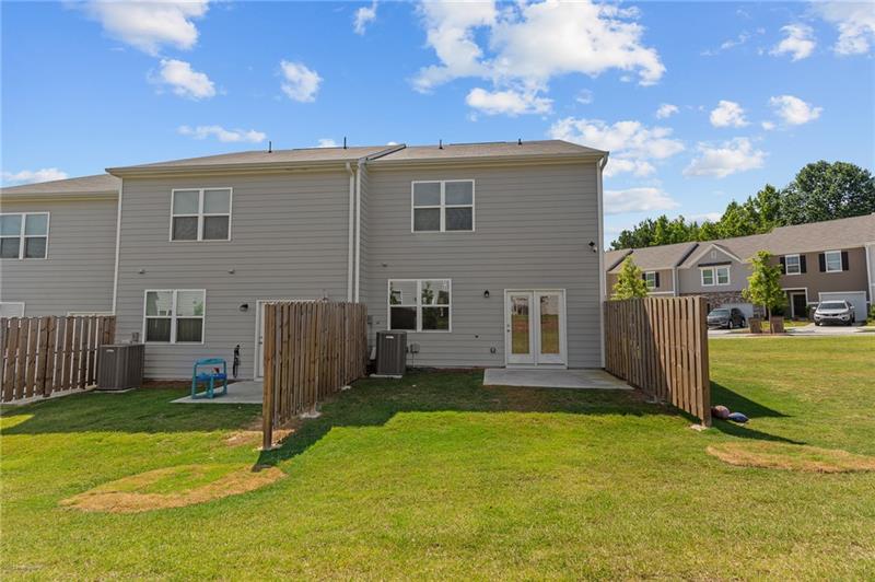 103 Rydal Way Winder, GA 30680 - Photo 27 of 31 a backyard of a house with barbeque oven and outdoor seating