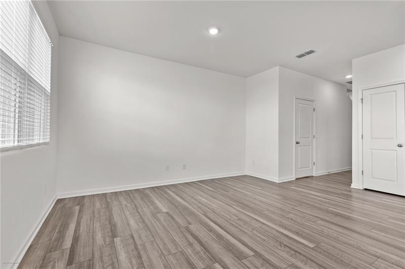 103 Rydal Way Winder, GA 30680 - Photo 6 of 31 a view of an empty room with wooden floor and a window