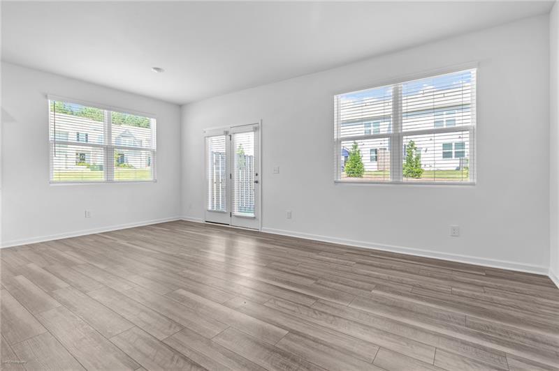103 Rydal Way Winder, GA 30680 - Photo 8 of 31 a view of an empty room with wooden floor and a window