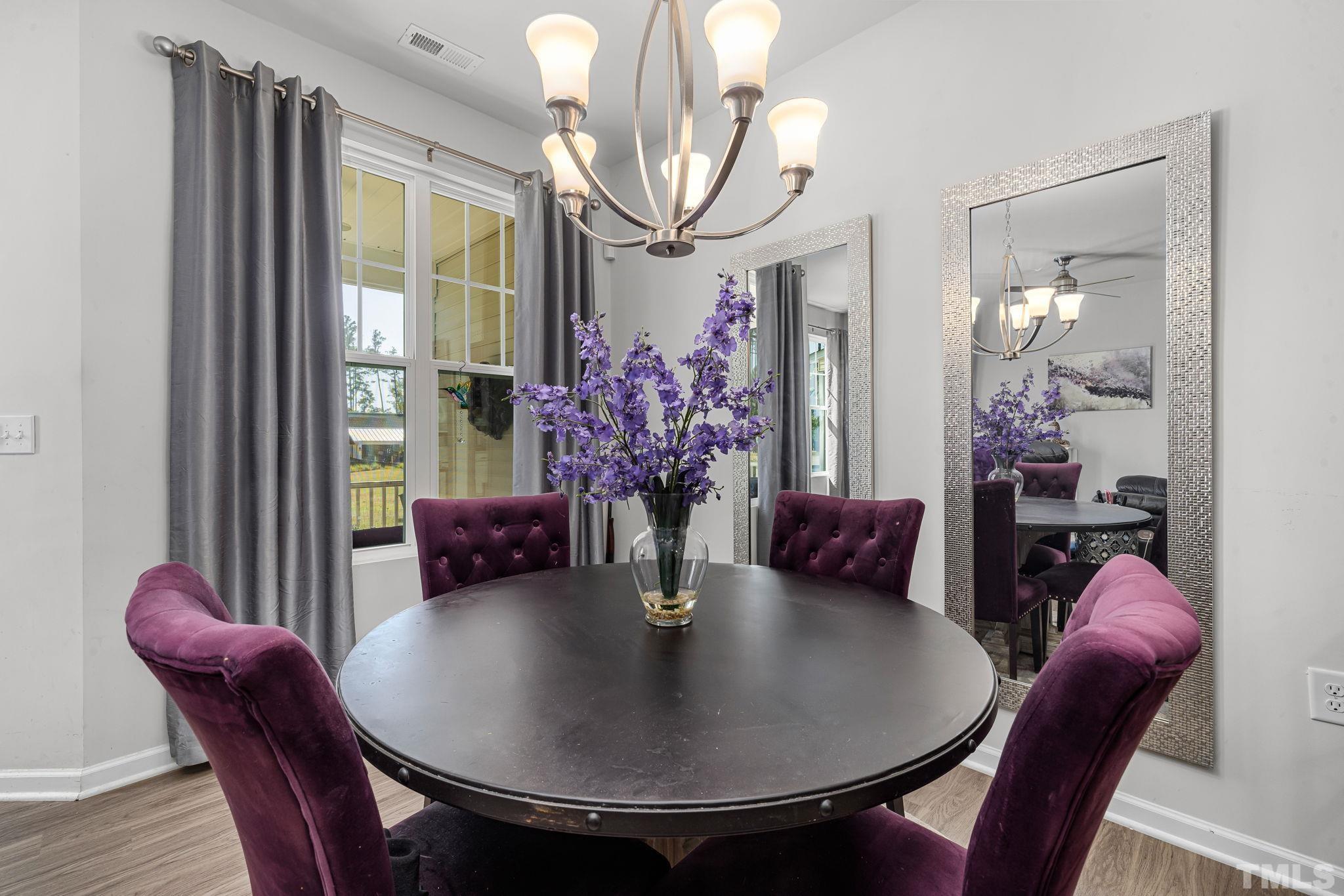 6084 Beale Loop Raleigh, NC 27616 - Photo 11 of 30 a view of a dining room with furniture and wooden floor