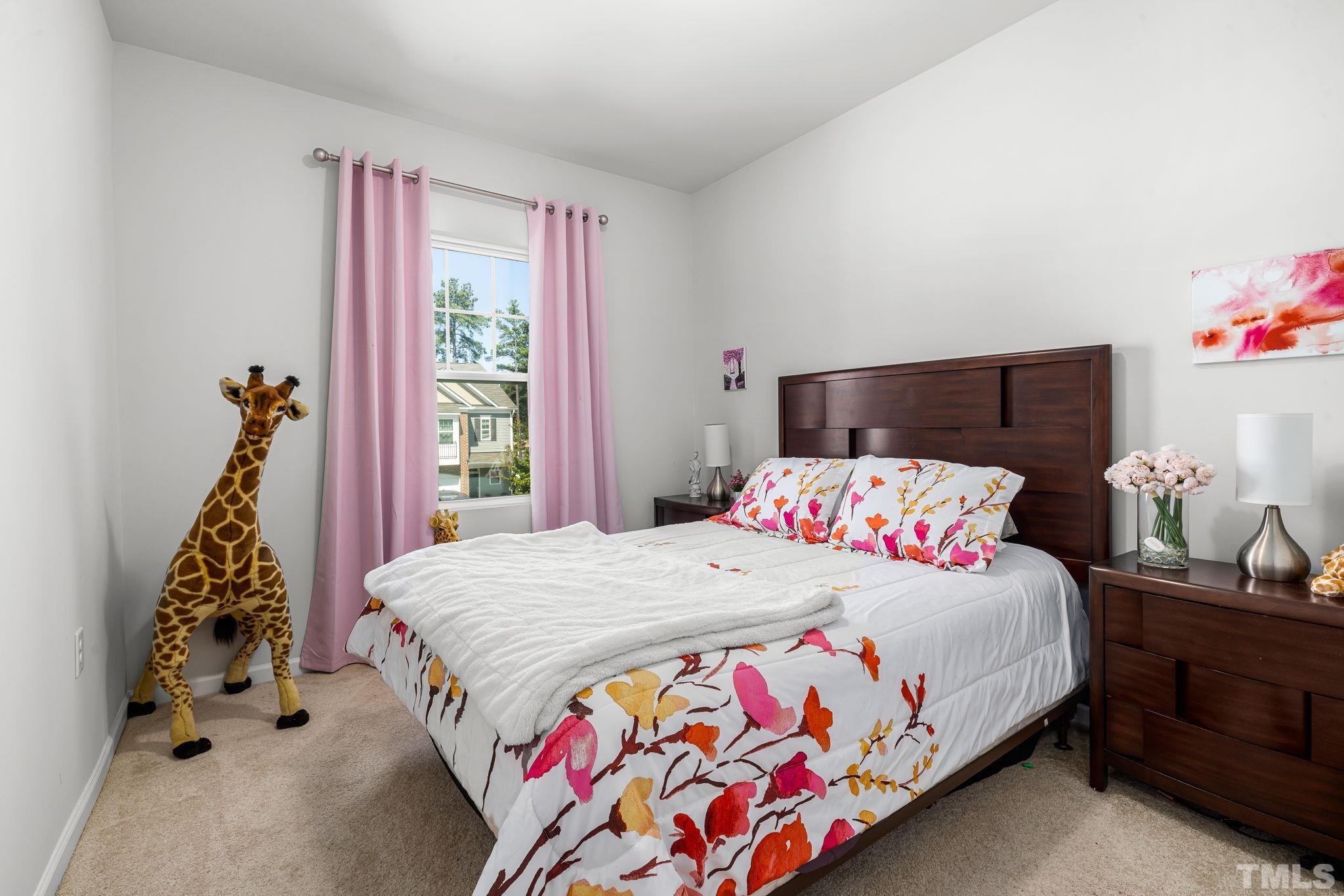 6084 Beale Loop Raleigh, NC 27616 - Photo 14 of 30 a bedroom with a bed and a window