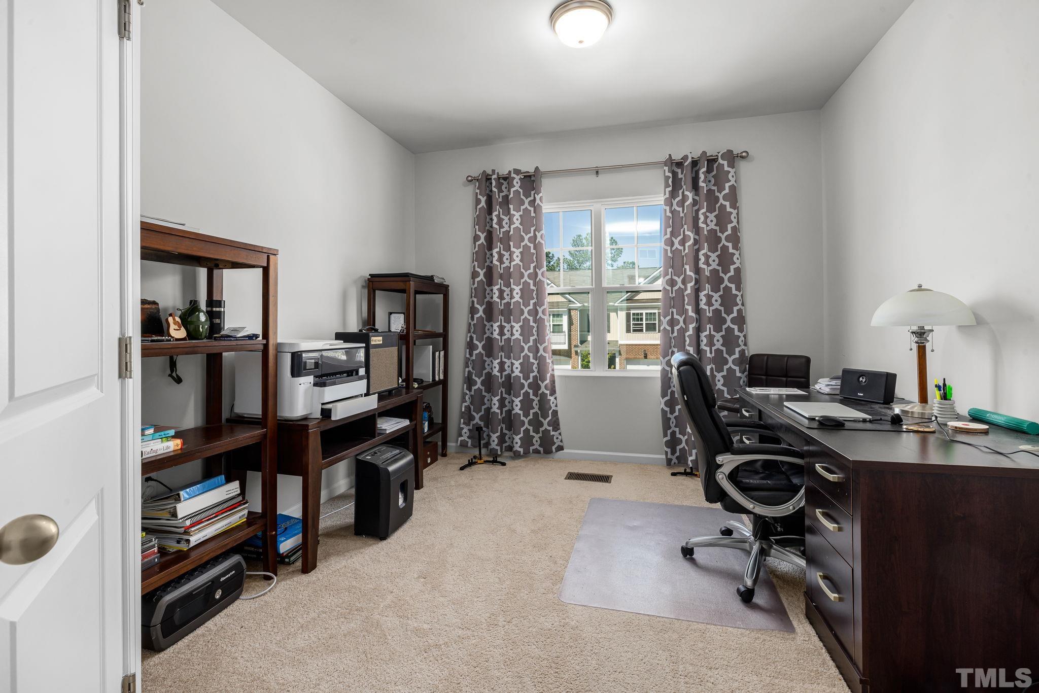 6084 Beale Loop Raleigh, NC 27616 - Photo 16 of 30 a view of a workspace with furniture and a window