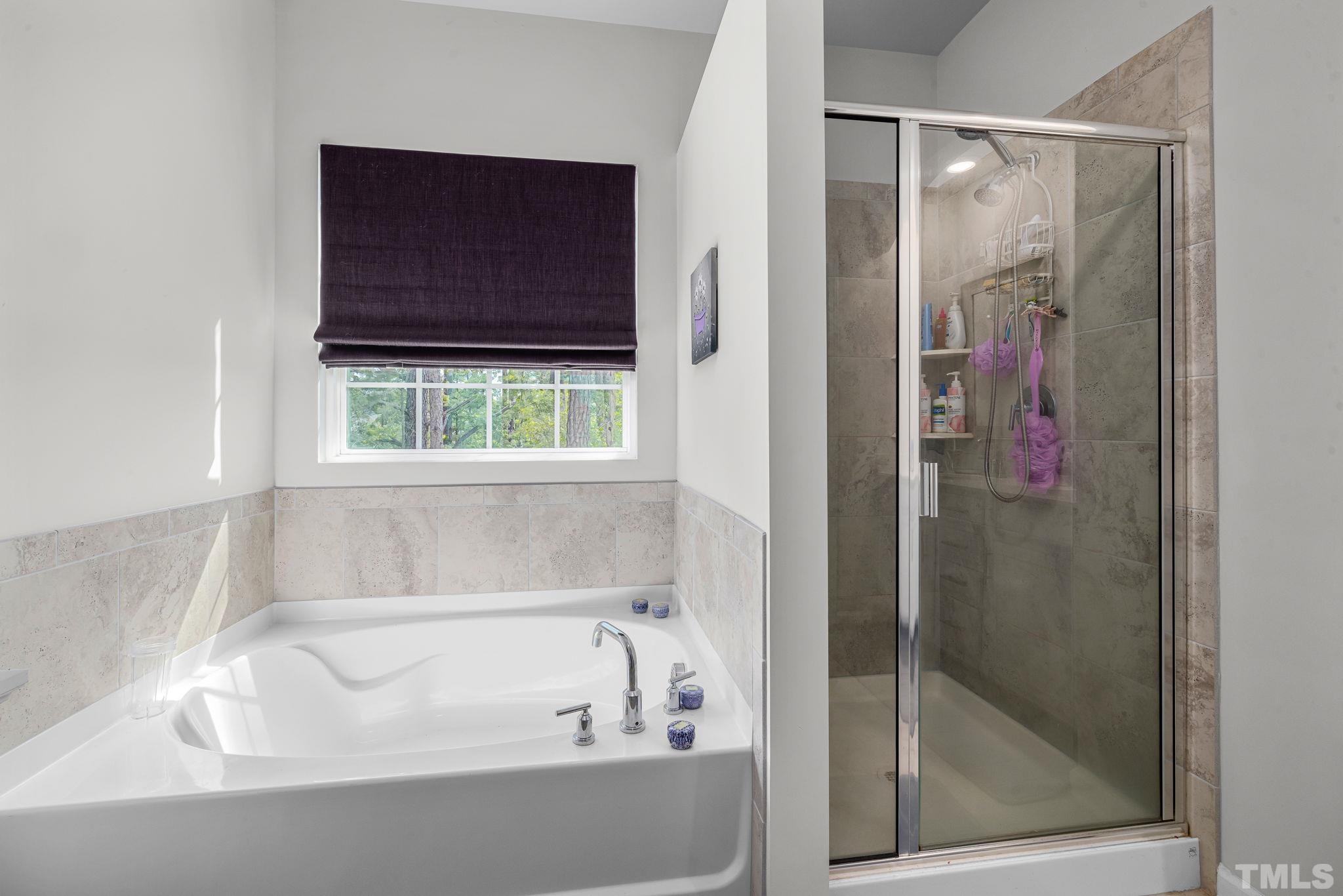 6084 Beale Loop Raleigh, NC 27616 - Photo 23 of 30 a bathroom with a bathtub and a shower