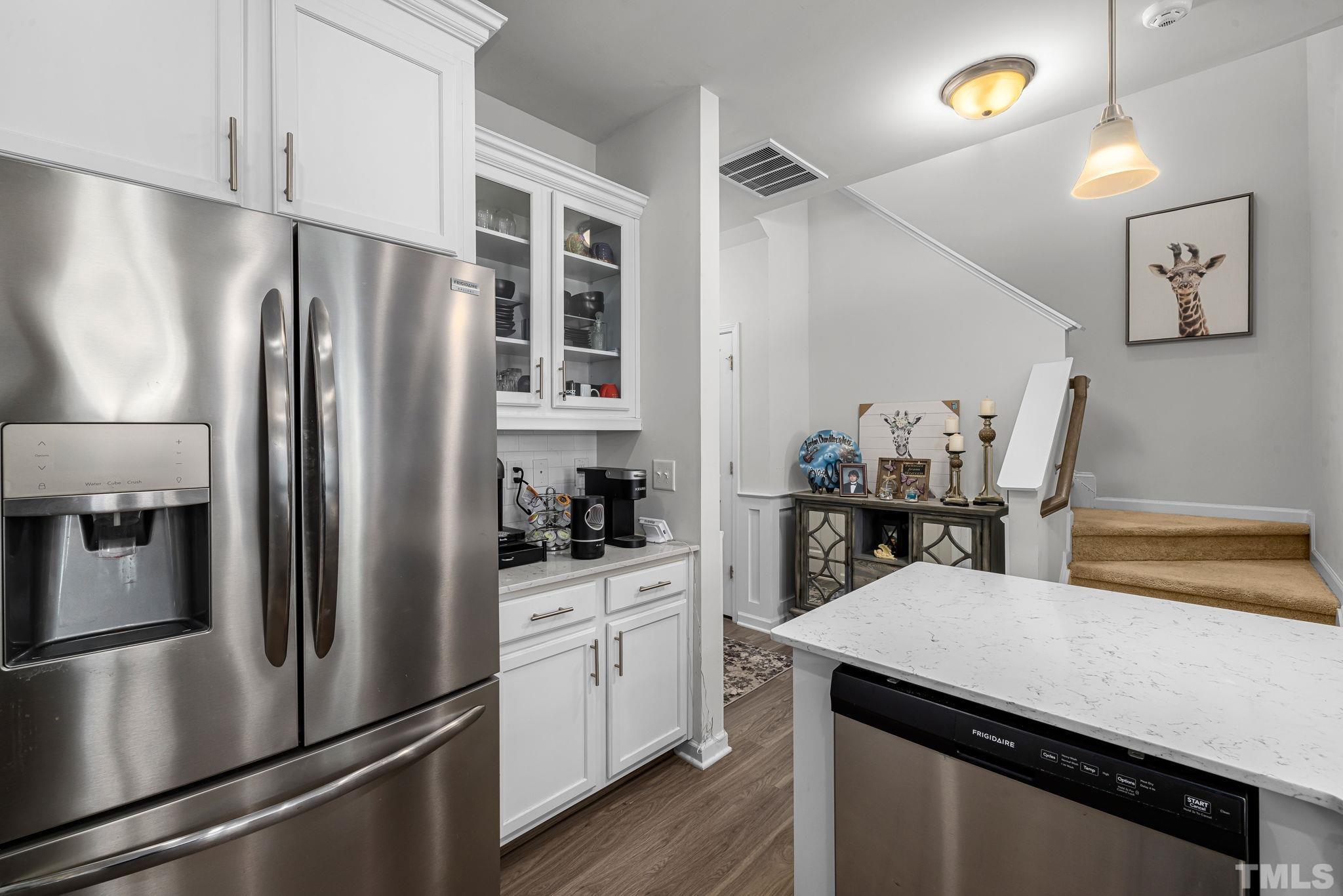 6084 Beale Loop Raleigh, NC 27616 - Photo 5 of 30 a kitchen with stainless steel appliances a refrigerator a sink a stove and cabinets