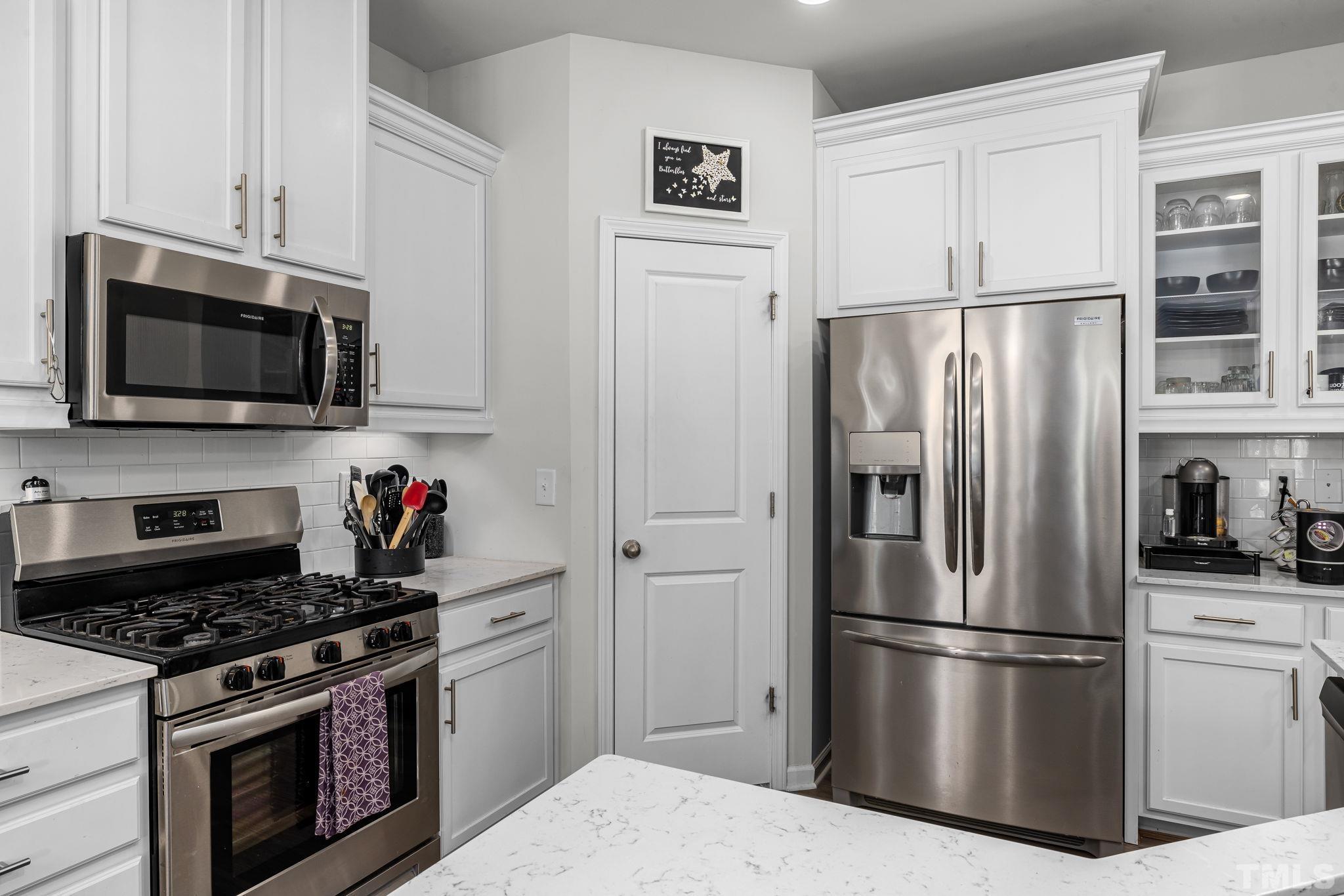 6084 Beale Loop Raleigh, NC 27616 - Photo 6 of 30 a kitchen with stainless steel appliances a refrigerator stove and microwave