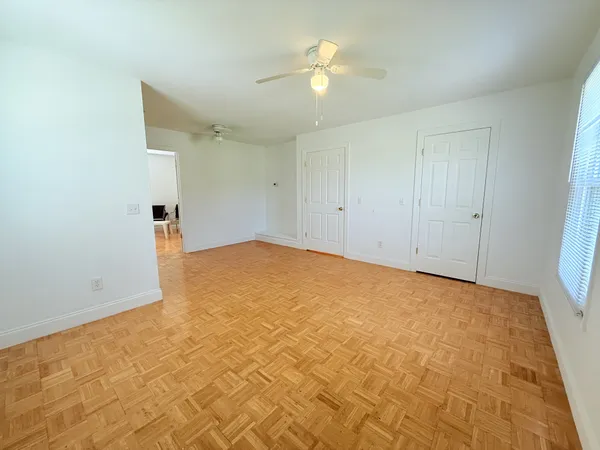 a spacious bedroom with a bed and a table in it