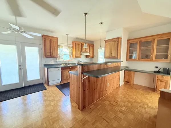 a large kitchen with stainless steel appliances granite countertop a sink and cabinets