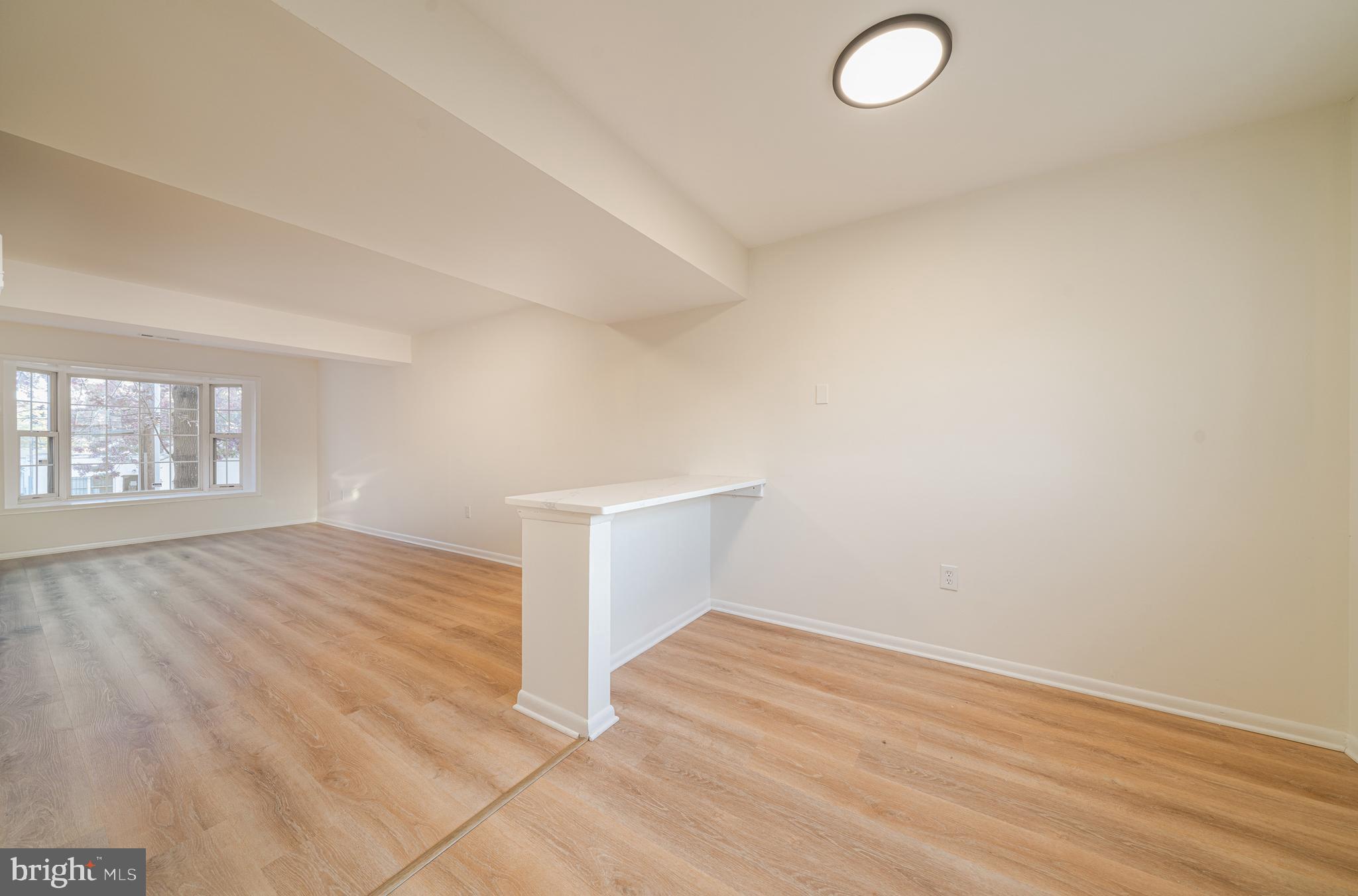 4631 Minnesota Avenue Northeast Washington, DC 20019 - Photo 12 of 28 an empty room with wooden floor and windows