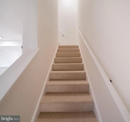 a view of staircase with white walls