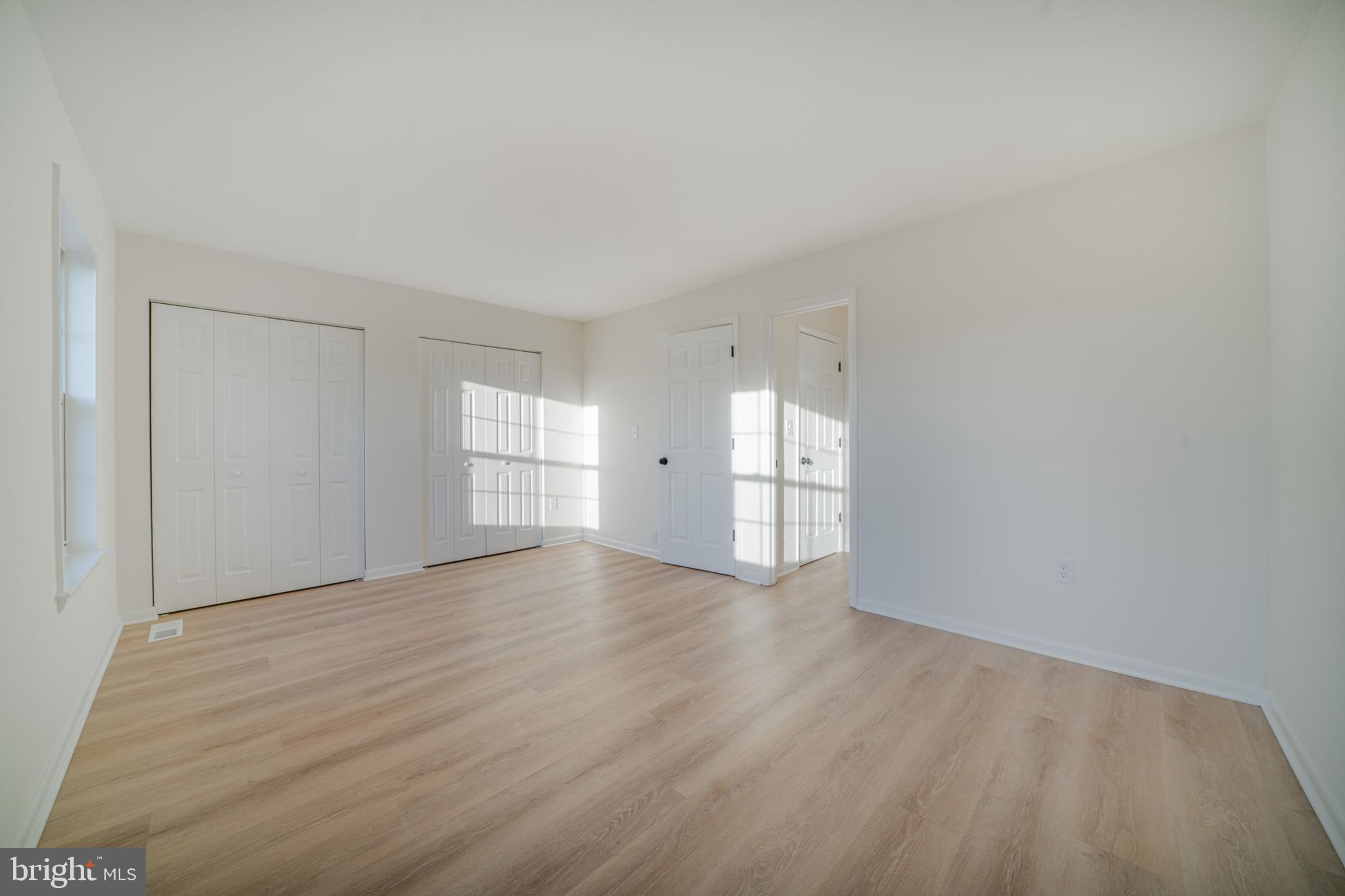 4631 Minnesota Avenue Northeast Washington, DC 20019 - Photo 14 of 28 a view of empty room with wooden floor and window