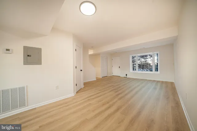 a view of an empty room and a window