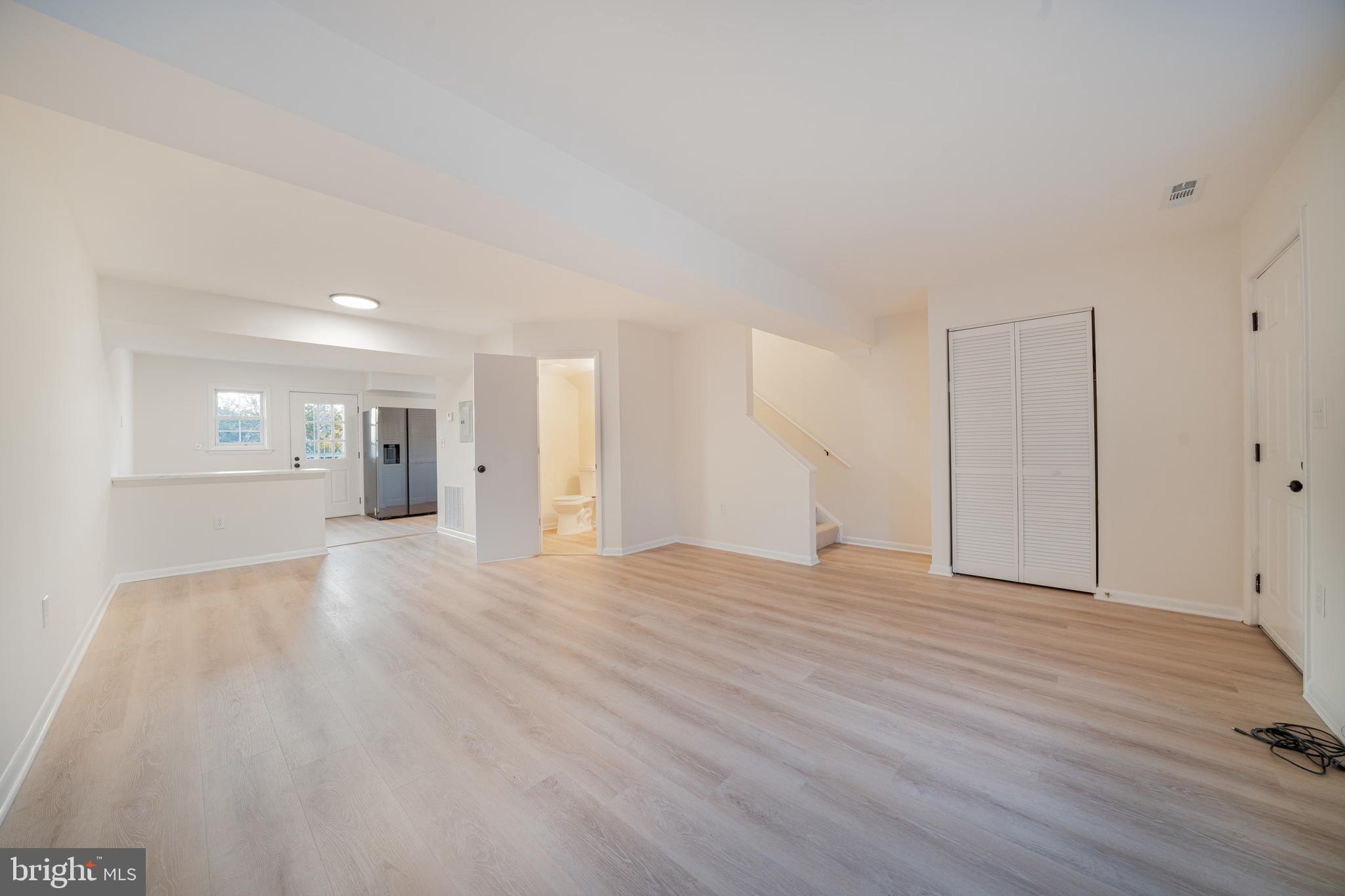 4631 Minnesota Avenue Northeast Washington, DC 20019 - Photo 7 of 28 a view of empty room with wooden floor and kitchen