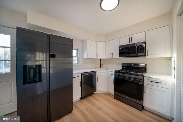 a kitchen with a refrigerator stove and microwave