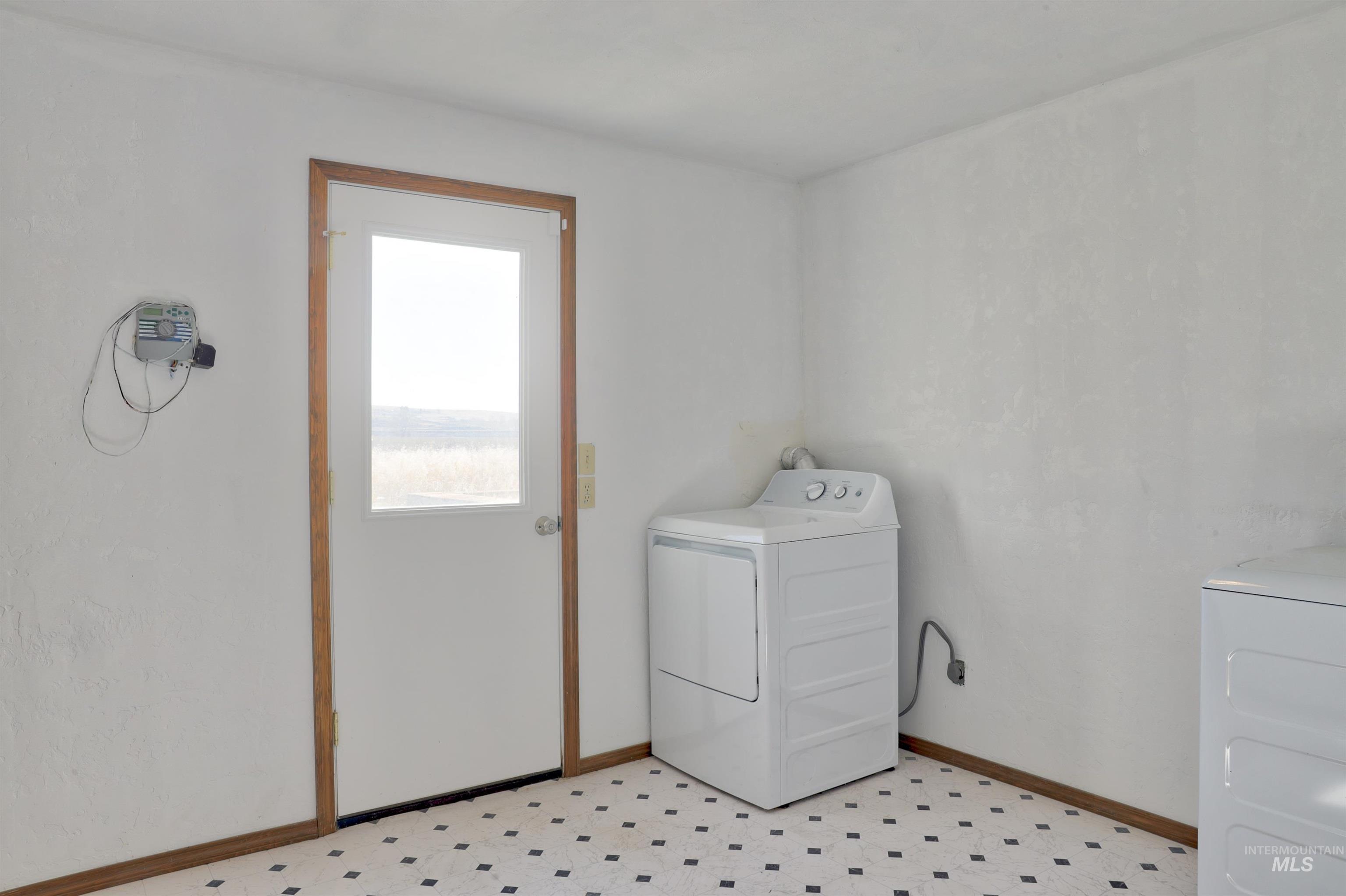 8027 Chuckar Lane Boise, ID 83709 - Photo 19 of 19 Laundry room with light floors and washing machine and clothes dryer