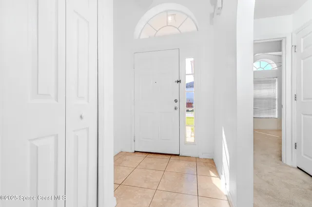 an empty room with wooden floor and mirror