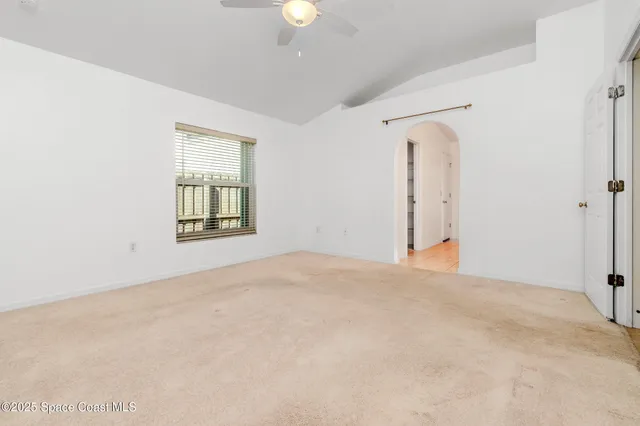 an empty room with windows and closet