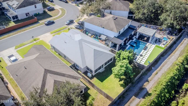 an aerial view of a house with a garden and swimming pool