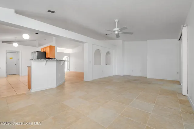 a view of a kitchen with a sink and a chandelier fan