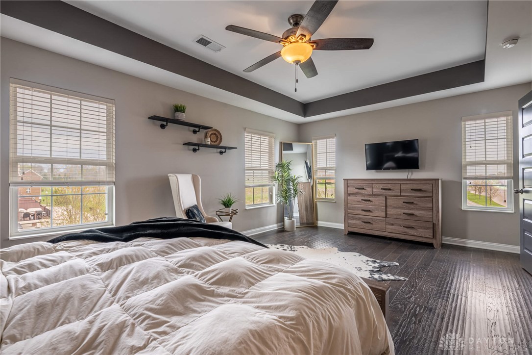407 Brownstone Row Springboro, OH 45066 - Photo 27 of 54 This spacious bedroom features ample natural light and rich wood flooring.