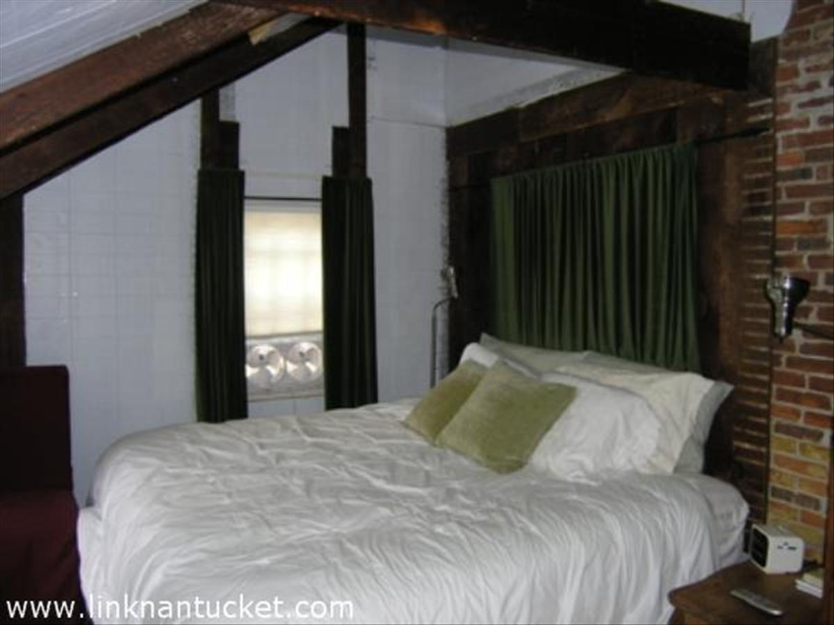 16 Vestal Street Nantucket, MA 02554 - Photo 10 of 10 a bedroom with a bed and a window