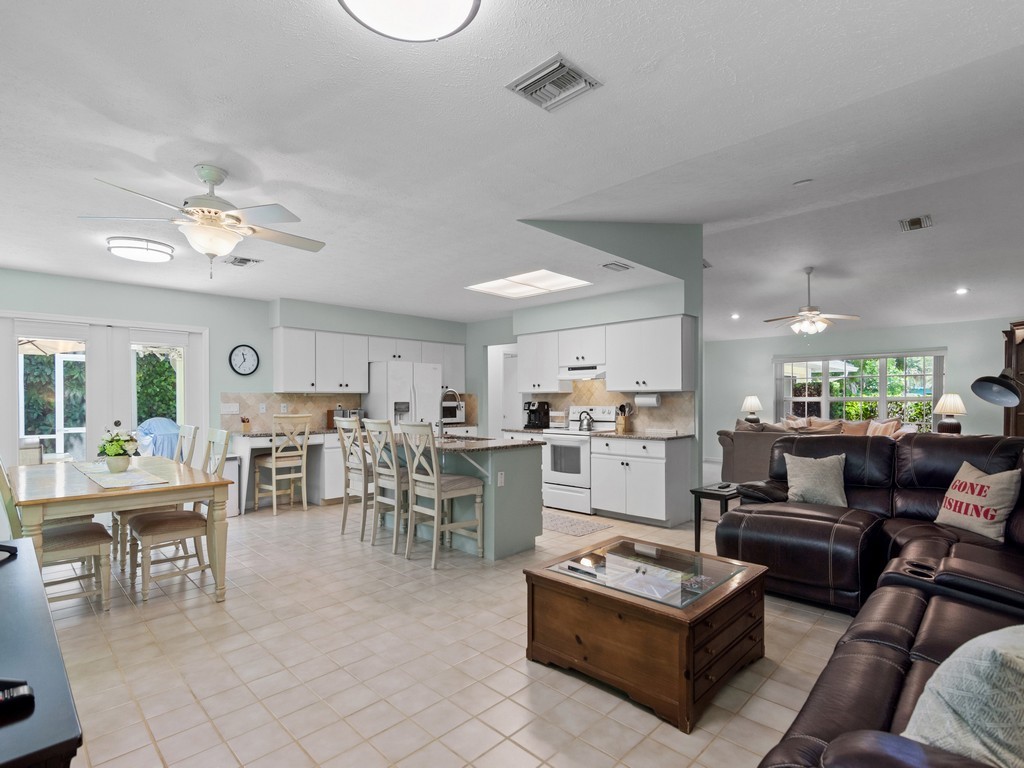 765 Date Palm Road Vero Beach, FL 32963 - Photo 13 of 36 a living room with furniture kitchen view and a dining table