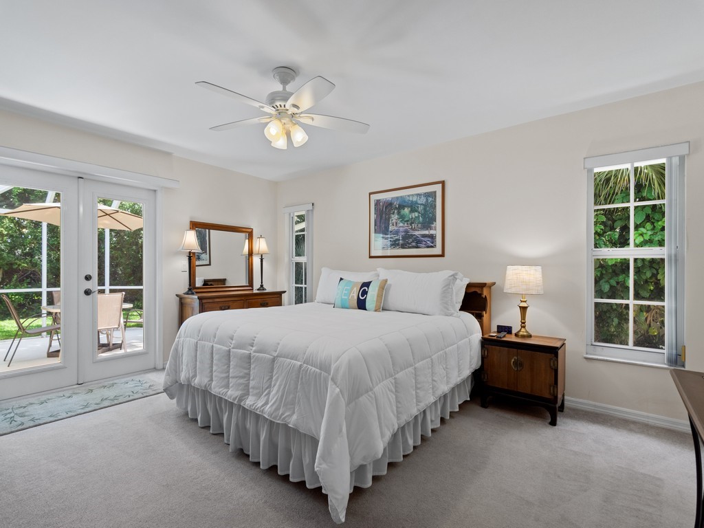 765 Date Palm Road Vero Beach, FL 32963 - Photo 17 of 36 a bed room with a bed and a chandelier