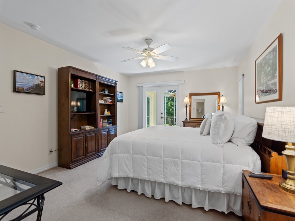 765 Date Palm Road Vero Beach, FL 32963 - Photo 18 of 36 a bedroom with a large bed and a chandelier