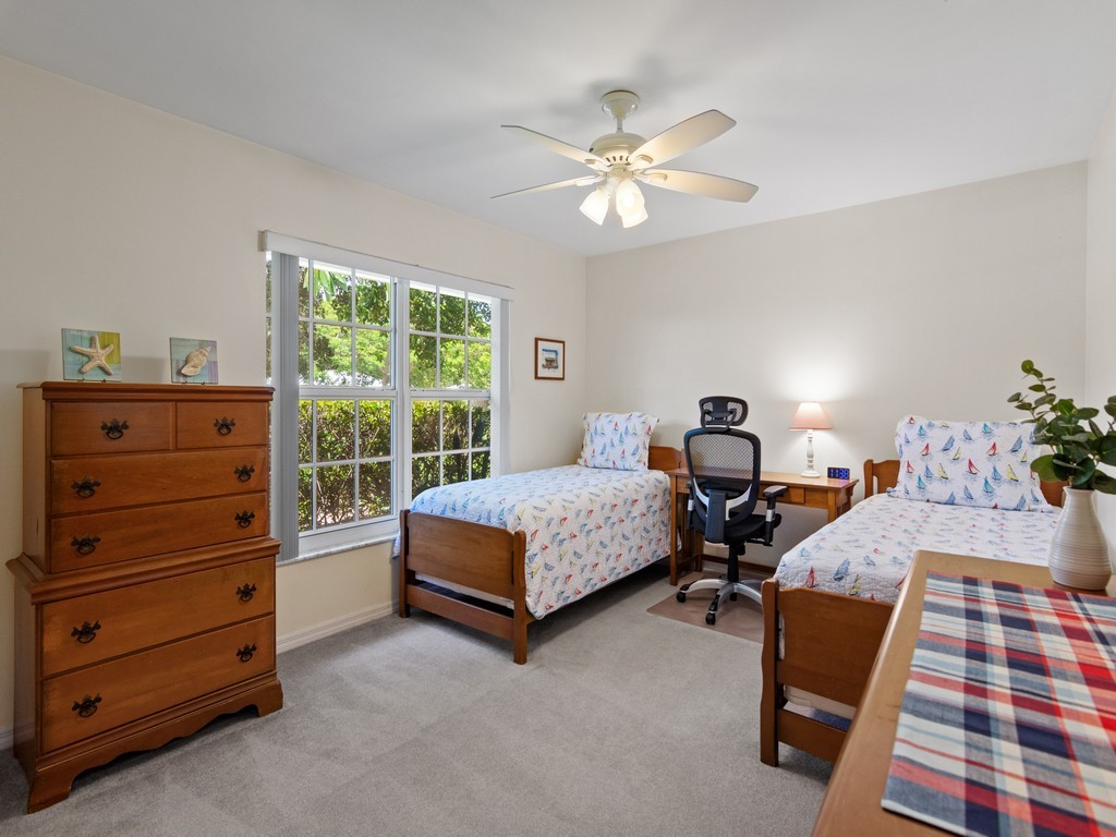 765 Date Palm Road Vero Beach, FL 32963 - Photo 21 of 36 a bedroom with a bed and a chandelier