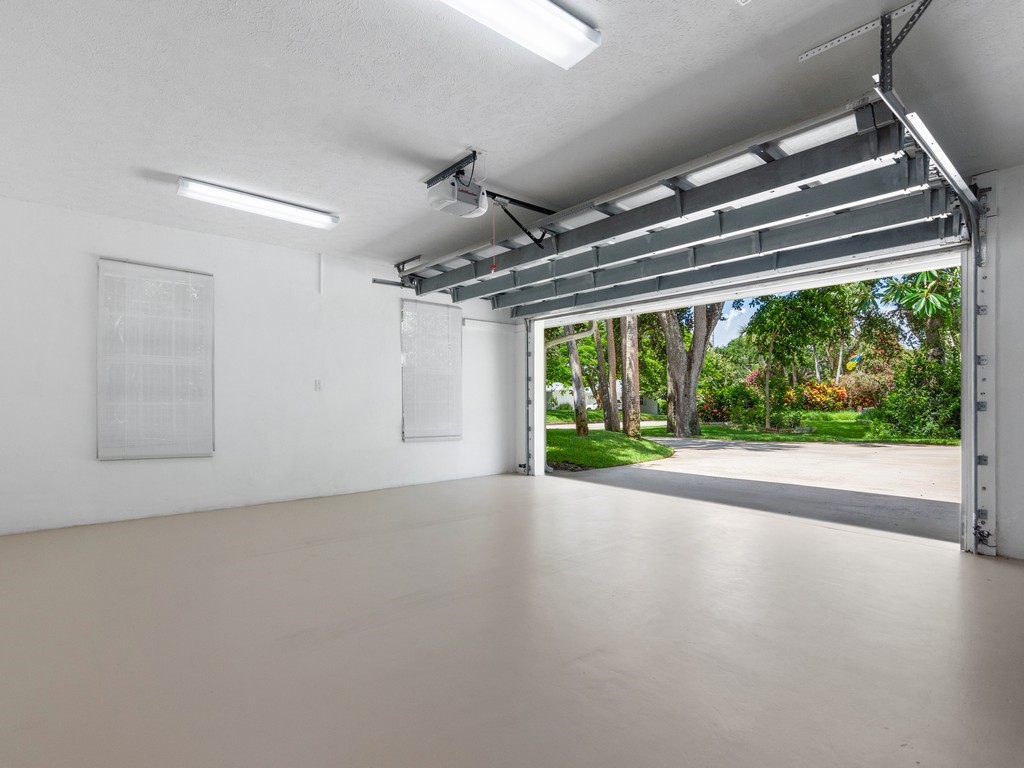 765 Date Palm Road Vero Beach, FL 32963 - Photo 24 of 36 a view of a room with wooden floor a ceiling fan and windows