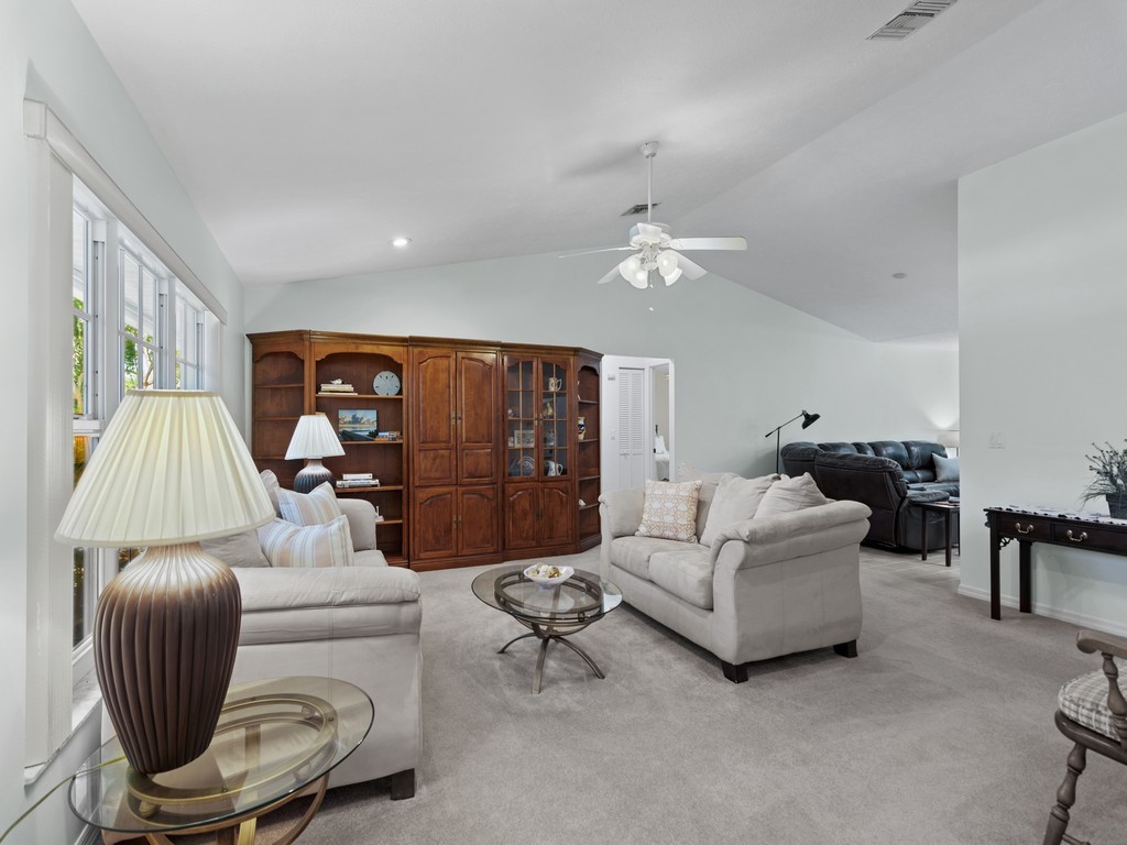 765 Date Palm Road Vero Beach, FL 32963 - Photo 3 of 36 a living room with furniture and a chandelier