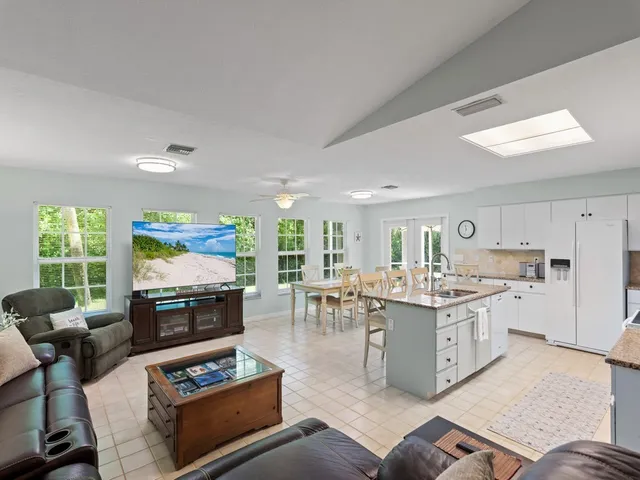 a kitchen with white cabinets and sink