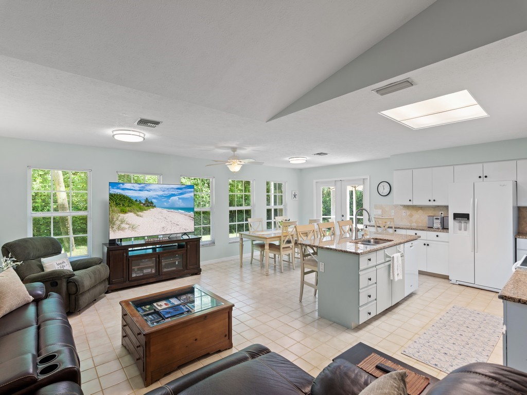 765 Date Palm Road Vero Beach, FL 32963 - Photo 7 of 36 a living room with furniture and a flat screen tv