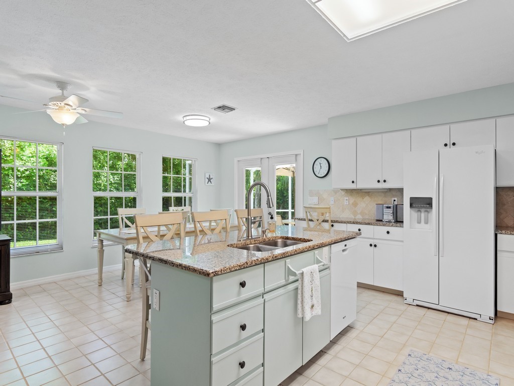 765 Date Palm Road Vero Beach, FL 32963 - Photo 8 of 36 a kitchen with white cabinets and sink