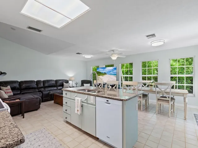 a kitchen with a stove a refrigerator and white cabinets
