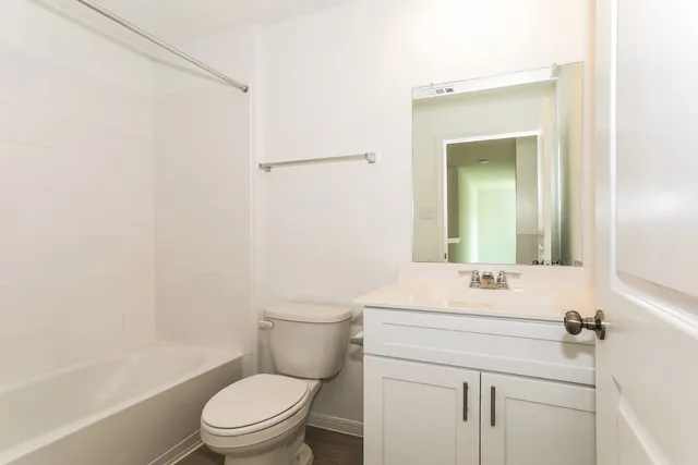 a view of a house with a big yard and large tree