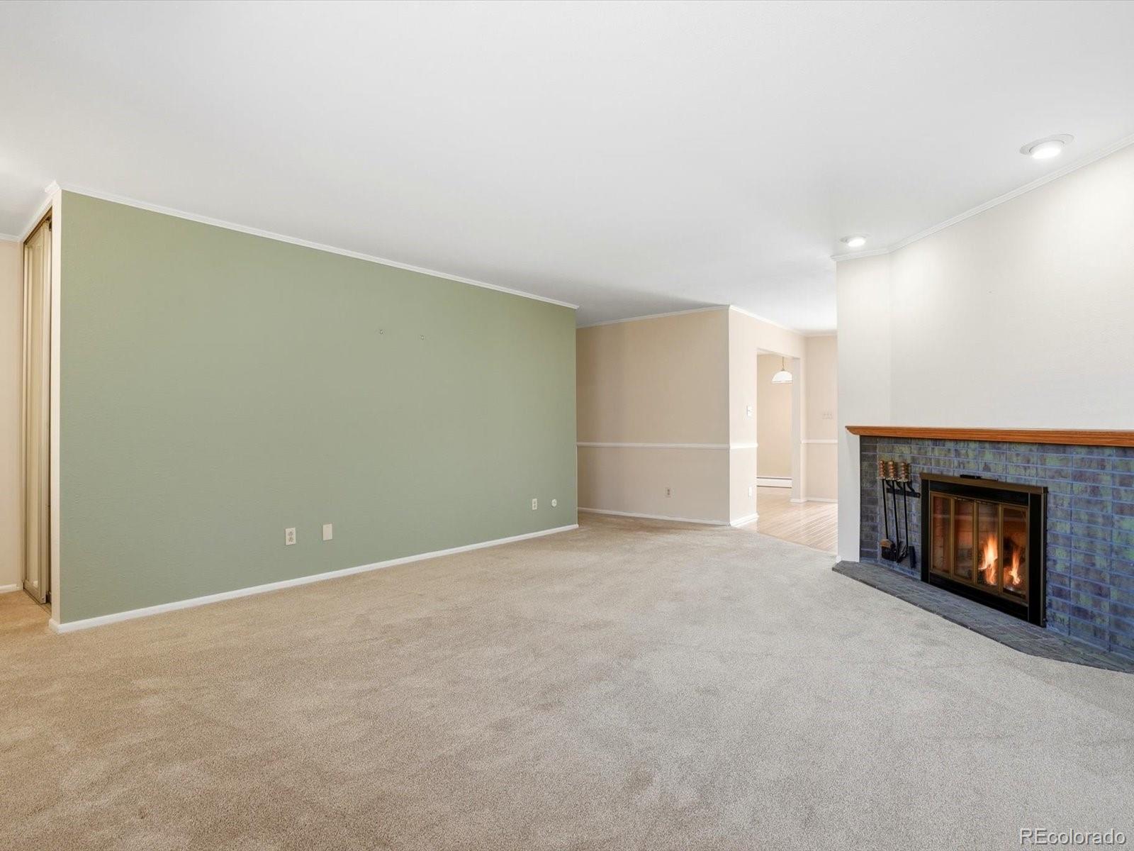 3330 South Oneida Way Denver, CO 80224 - Photo 4 of 36 a view of an empty room with fire place and a fireplace