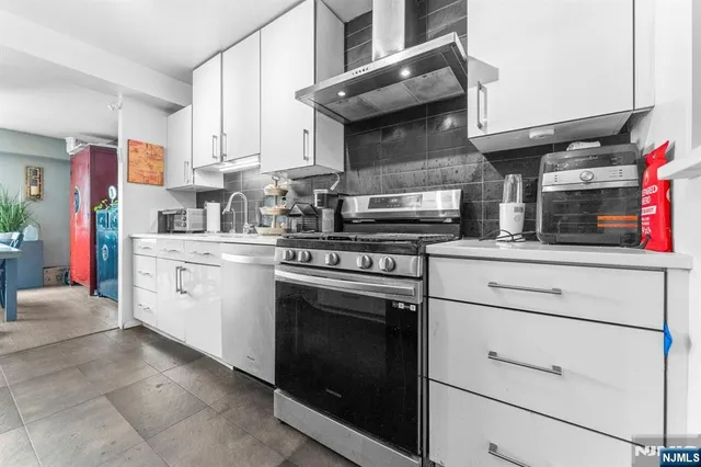 a kitchen with stainless steel appliances granite countertop a stove and a sink