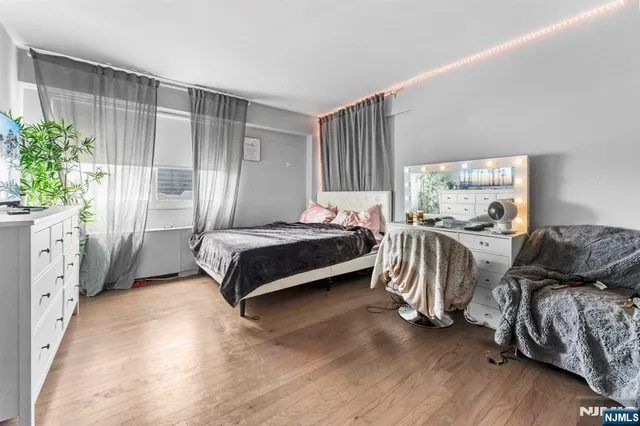 a bedroom with furniture and a window