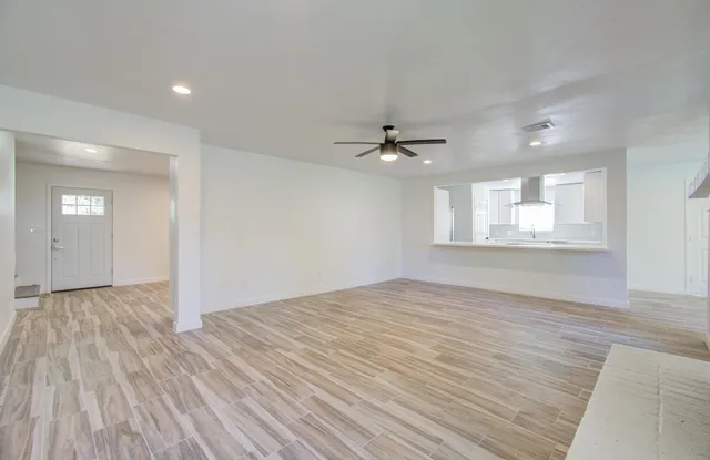 wooden floor in an empty room with a window