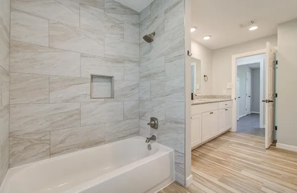 a bathroom with a bathtub and a sink