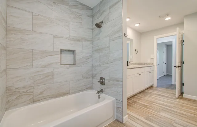 a bathroom with a bathtub and a sink