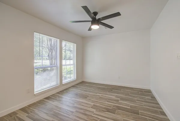wooden floor in an empty room with a window