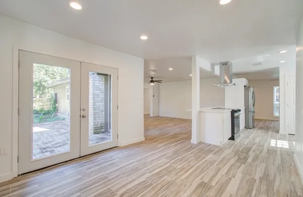 a view of a kitchen with wooden floor and a window