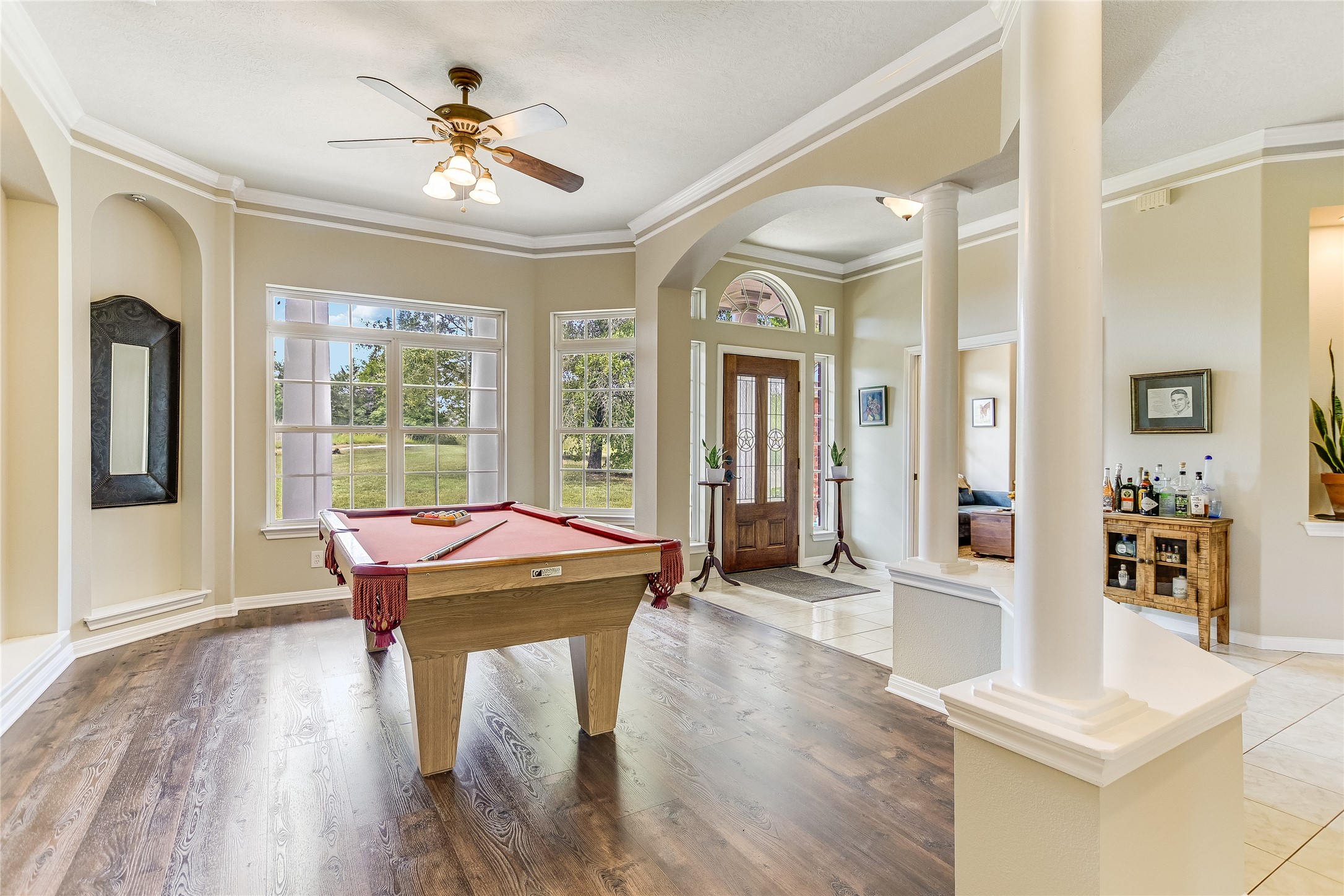 741 Knobbs Road McDade, TX 78650 - Photo 7 of 38 Elegant columns and a rich wooden door welcome you, setting a sophisticated tone.