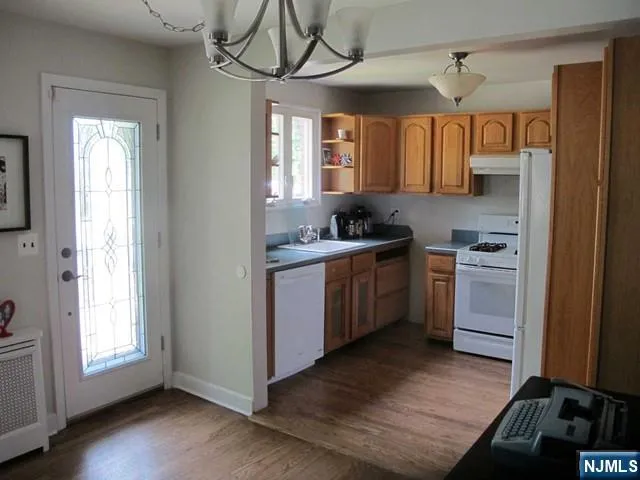 a kitchen with a sink cabinets stainless steel appliances and a window