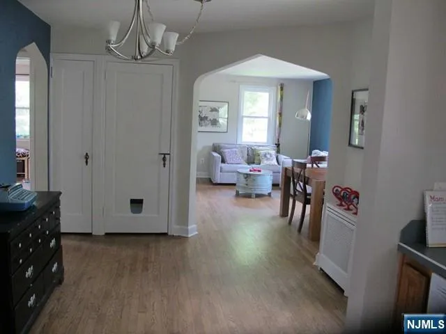 a view of a livingroom with furniture hardwood floor and windows
