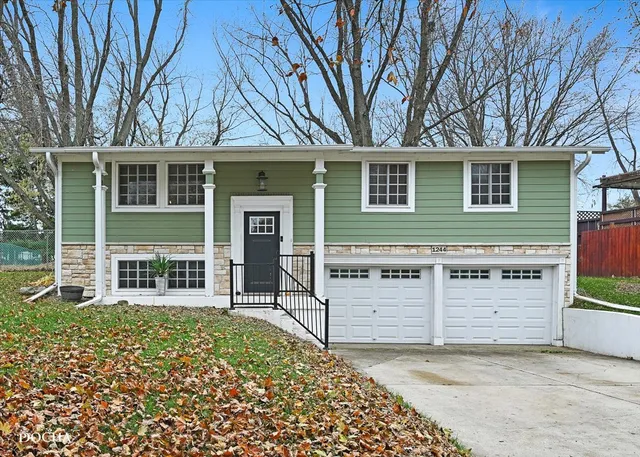 a view of a house with a large tree